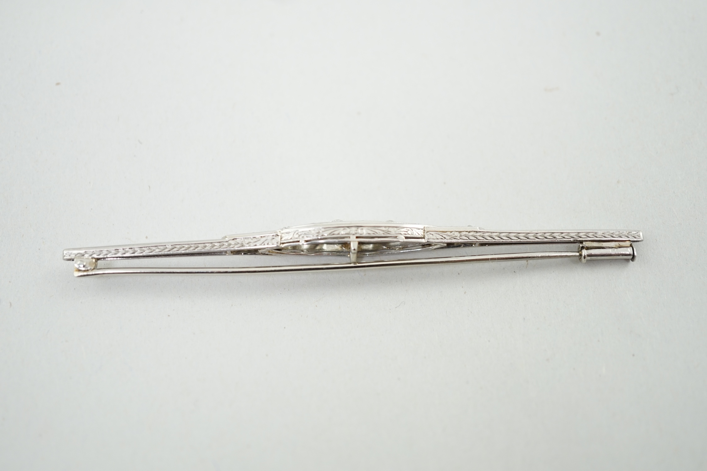 An early 20th century platinum? and diamond cluster set bar brooch